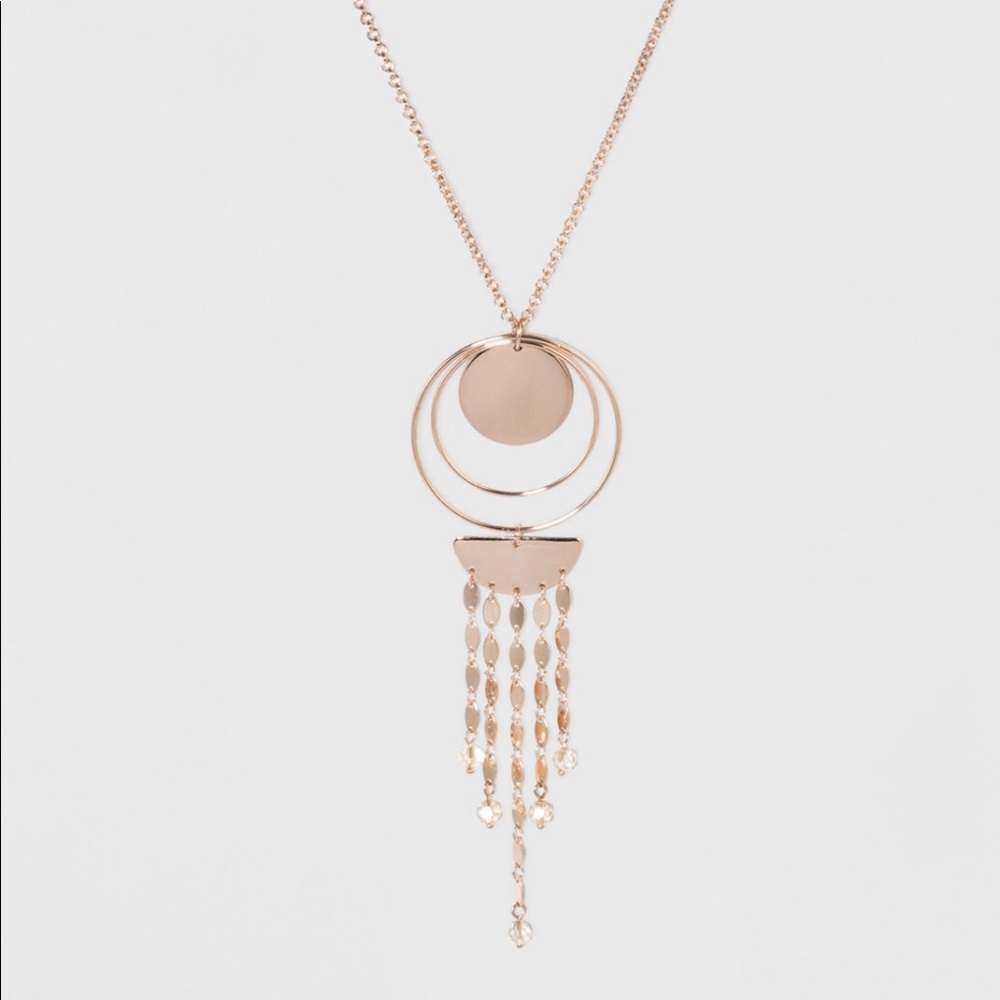 Rising sun gold tone pendant necklace